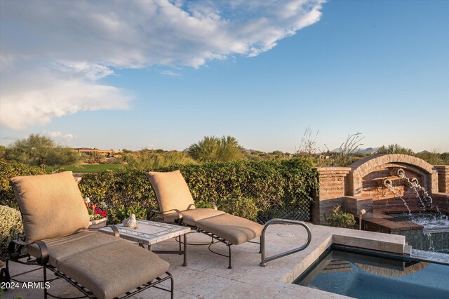 view of patio with pool water feature and a swimming pool with hot tub