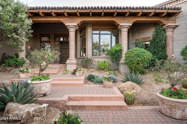 view of exterior entry with covered porch