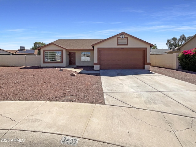 3407 N 67th Ln, Phoenix, AZ 85033 - ranch-style home with stucco siding, an attached garage, and driveway