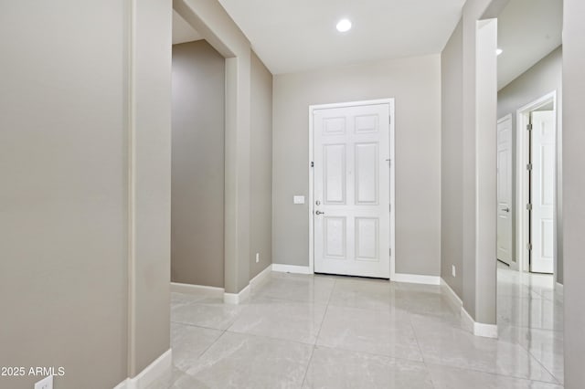 foyer with recessed lighting and baseboards