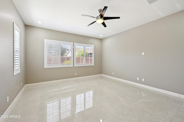 empty room with visible vents, recessed lighting, a ceiling fan, and baseboards