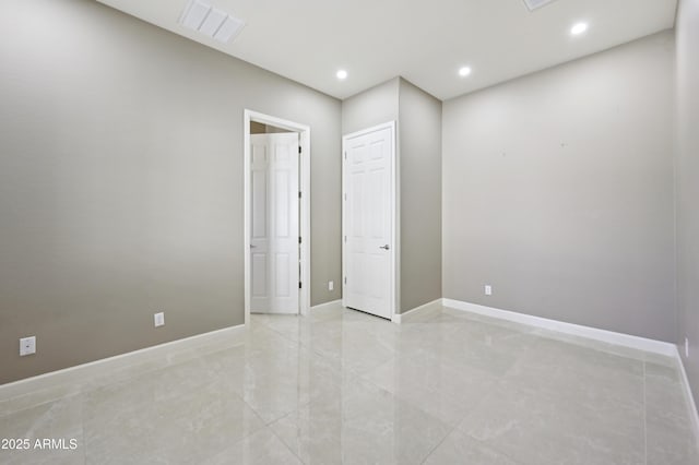 empty room with recessed lighting, baseboards, and visible vents