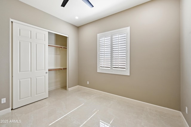 unfurnished bedroom with a closet, baseboards, and a ceiling fan