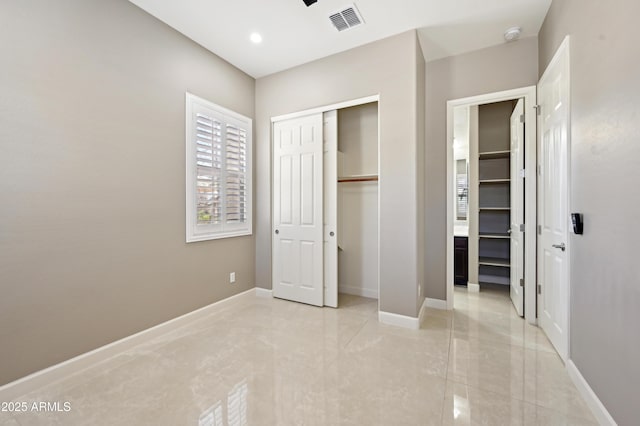 unfurnished bedroom featuring visible vents, baseboards, recessed lighting, a closet, and marble finish floor