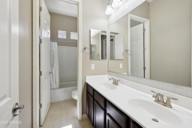 full bath with tile patterned flooring, double vanity, toilet, and a sink