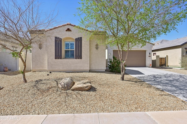 mediterranean / spanish home with stucco siding, a garage, concrete driveway, and a tile roof