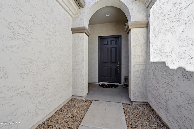 view of exterior entry featuring stucco siding