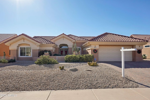 mediterranean / spanish-style home with a garage