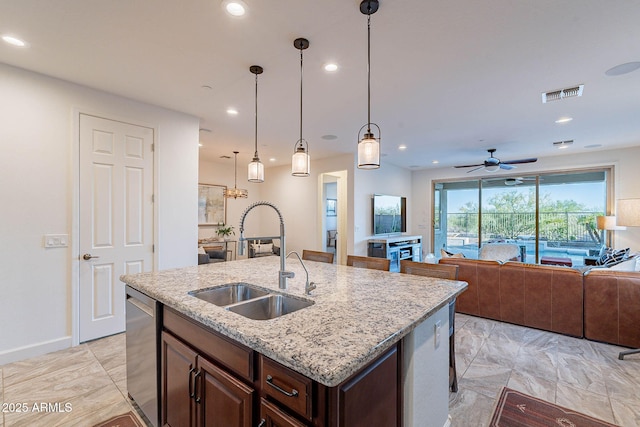 13719 W Amberwing St, Peoria, AZ 85383 - kitchen featuring a sink, dishwasher, recessed lighting, open floor plan, and a center island with sink