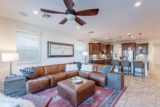 13719 W Amberwing St, Peoria, AZ 85383 - living area featuring a ceiling fan and recessed lighting