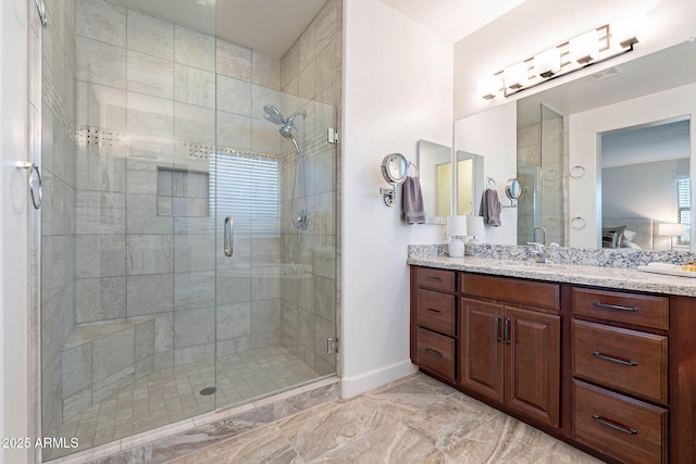 13719 W Amberwing St, Peoria, AZ 85383 - bathroom featuring a stall shower, vanity, baseboards, and marble finish floors