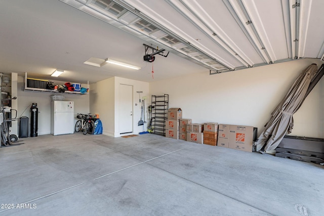 13719 W Amberwing St, Peoria, AZ 85383 - garage featuring freestanding refrigerator and a garage door opener