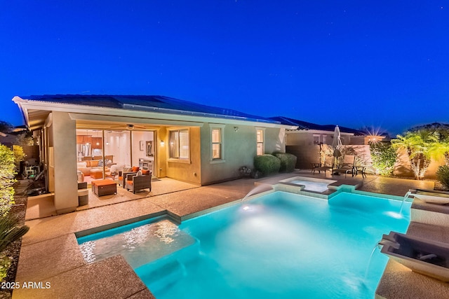 13719 W Amberwing St, Peoria, AZ 85383 - back of house at twilight featuring an outdoor hangout area, solar panels, a patio, and a ceiling fan