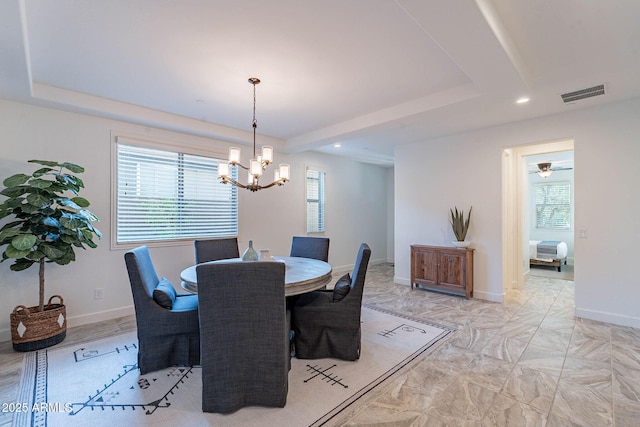 13719 W Amberwing St, Peoria, AZ 85383 - dining space featuring a chandelier, healthy amount of natural light, a tray ceiling, recessed lighting, and baseboards