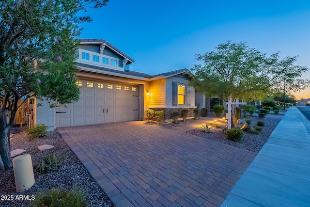 13719 W Amberwing St, Peoria, AZ 85383 - craftsman inspired home with decorative driveway, stone siding, and a garage