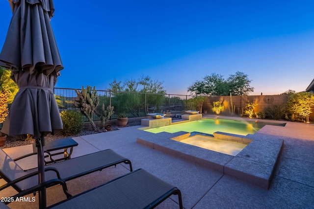 13719 W Amberwing St, Peoria, AZ 85383 - pool at dusk with an in-ground hot tub, a fenced backyard, and a patio area