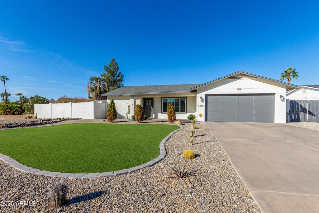 ranch-style home featuring a garage and a front yard