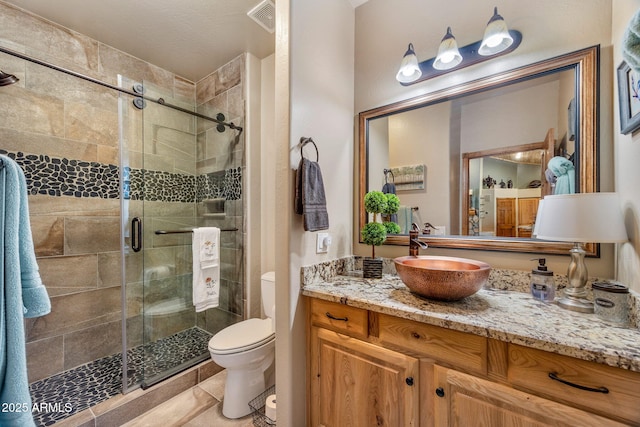 2640 W Maple Ln, Show Low, AZ 85901 - full bathroom featuring vanity, toilet, a stall shower, and tile patterned floors
