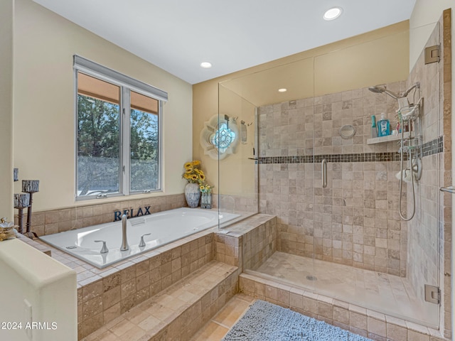 bathroom featuring shower with separate bathtub and tile patterned flooring