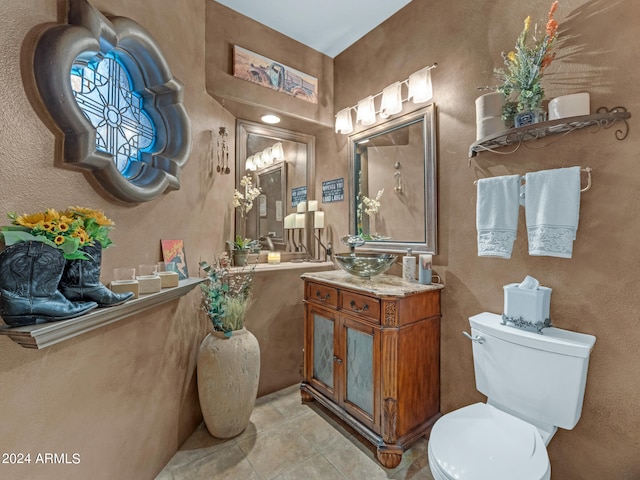 bathroom featuring vanity, toilet, and tile patterned floors