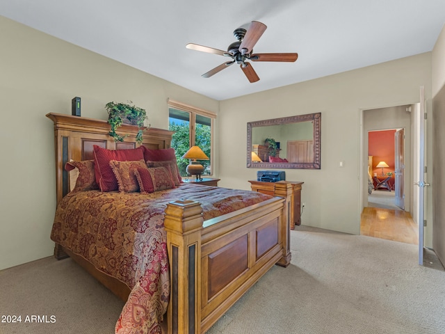 bedroom featuring light carpet and ceiling fan