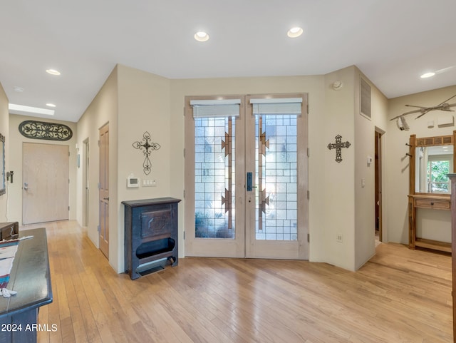 doorway with french doors and light hardwood / wood-style floors