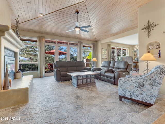 living room with ceiling fan, a stone fireplace, high vaulted ceiling, and wooden ceiling