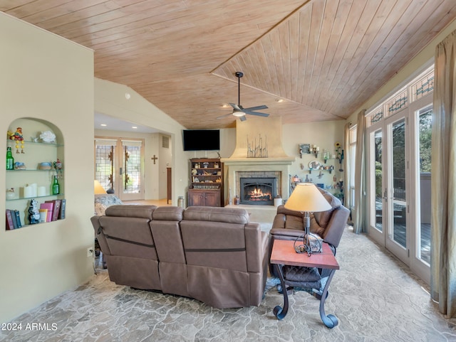 living room featuring lofted ceiling, a healthy amount of sunlight, a fireplace, and wood ceiling