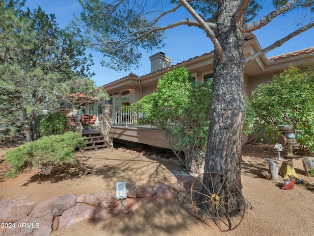 rear view of property with a wooden deck