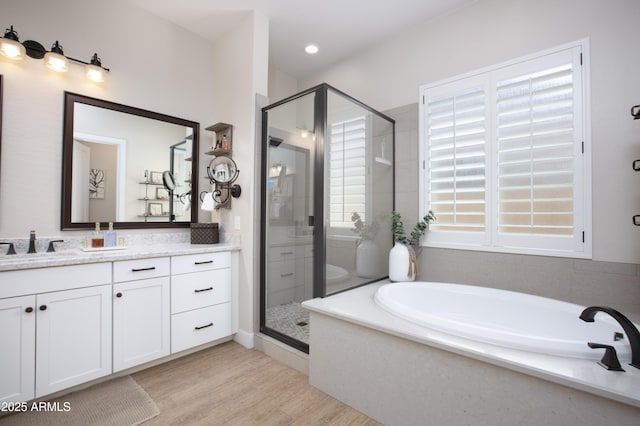 3118 E Gary Way, Phoenix, AZ 85042 - full bathroom featuring vanity, a bath, a shower stall, and wood finished floors