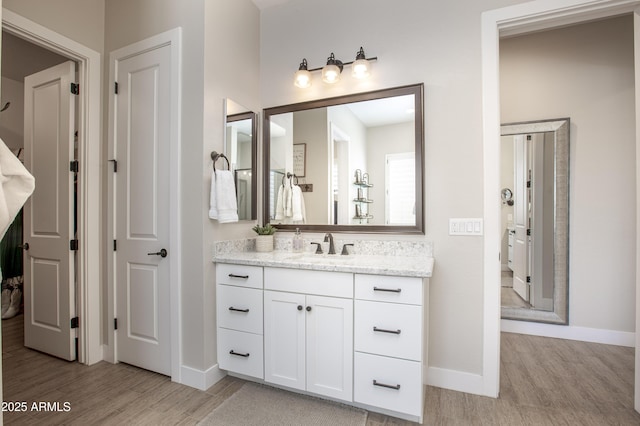 3118 E Gary Way, Phoenix, AZ 85042 - bathroom featuring wood finished floors, vanity, and baseboards