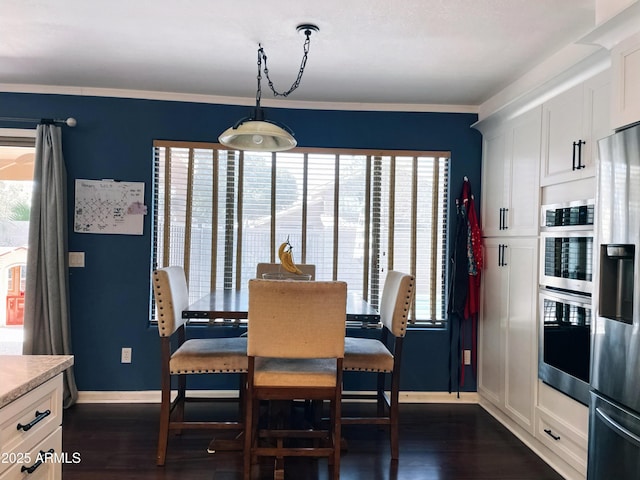 dining room featuring dark wood-style floors and baseboards