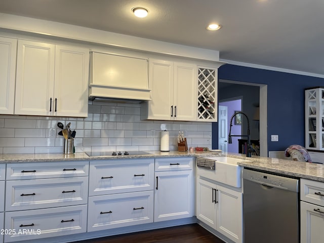 kitchen featuring tasteful backsplash, dishwasher, black electric cooktop, white cabinetry, and a sink