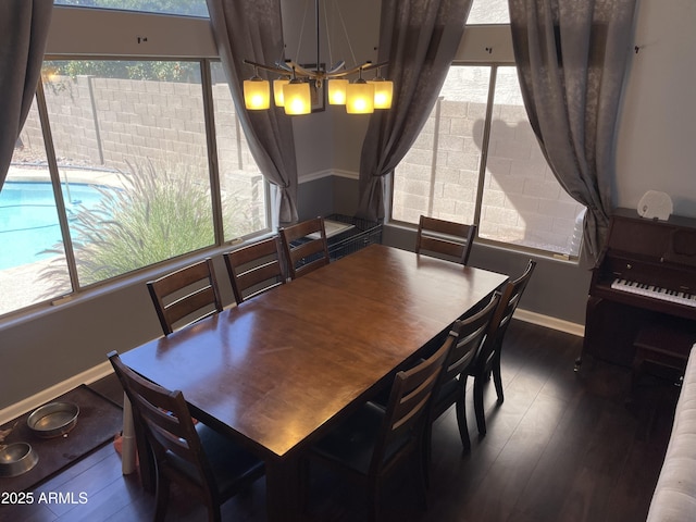 dining space with plenty of natural light, baseboards, and wood finished floors