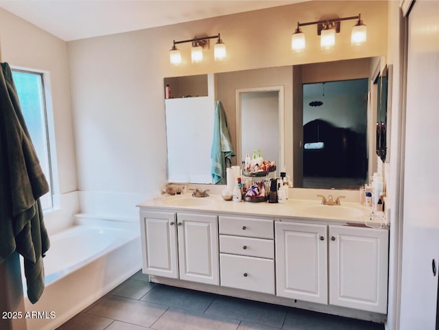 bathroom featuring double vanity, a garden tub, a sink, and tile patterned floors