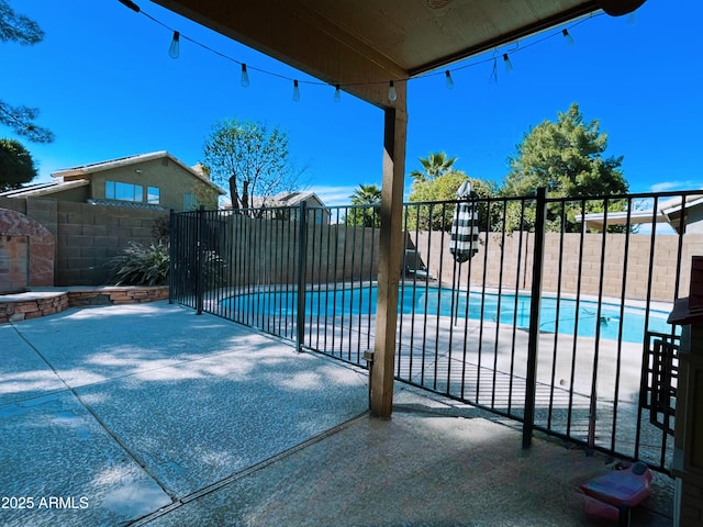 view of swimming pool with a patio, fence, and a fenced in pool