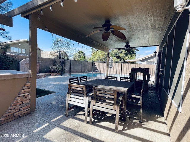 view of patio / terrace with outdoor dining space, a fenced backyard, and ceiling fan