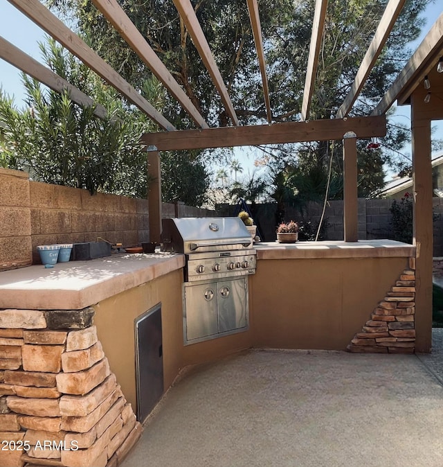 view of patio / terrace with area for grilling, a fenced backyard, and a pergola