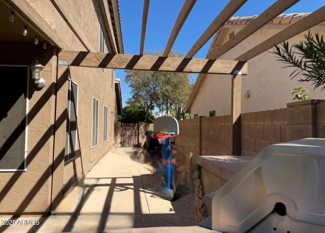 view of patio / terrace featuring fence and a pergola