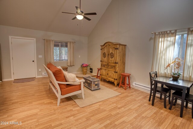 living room featuring high vaulted ceiling, light hardwood / wood-style flooring, and ceiling fan