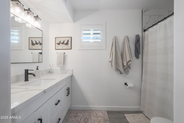 bathroom with vanity, plenty of natural light, hardwood / wood-style floors, and a shower with shower curtain