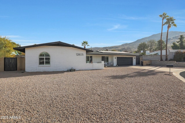 ranch-style house with a mountain view and a garage