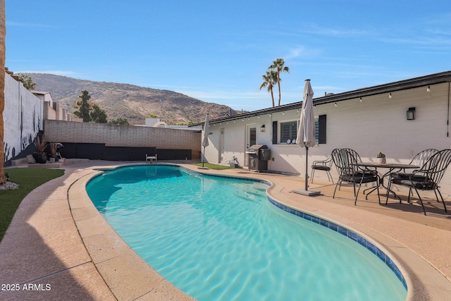 view of pool featuring a mountain view, grilling area, and a patio