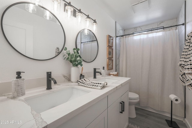 bathroom featuring vanity, hardwood / wood-style floors, walk in shower, and toilet