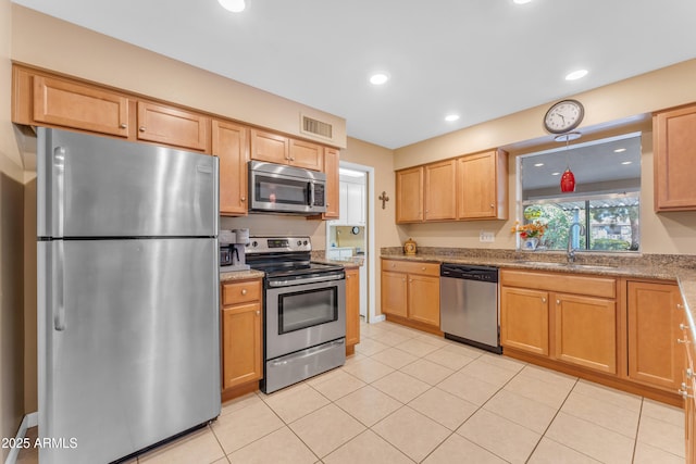 kitchen with visible vents, light tile patterned flooring, recessed lighting, a sink, and stainless steel appliances