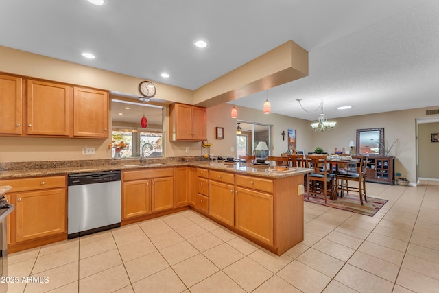 kitchen with decorative light fixtures, a peninsula, stainless steel dishwasher, light tile patterned flooring, and a sink