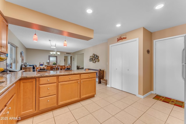 kitchen featuring a peninsula, light tile patterned floors, recessed lighting, and open floor plan