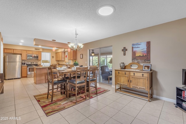 dining space featuring a notable chandelier, a textured ceiling, recessed lighting, light tile patterned floors, and baseboards