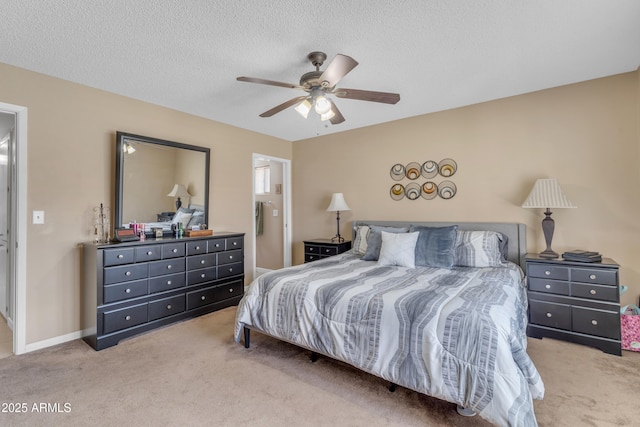 carpeted bedroom with a textured ceiling, baseboards, and a ceiling fan