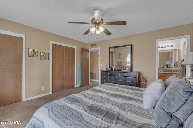 bedroom with visible vents, carpet, and a textured ceiling